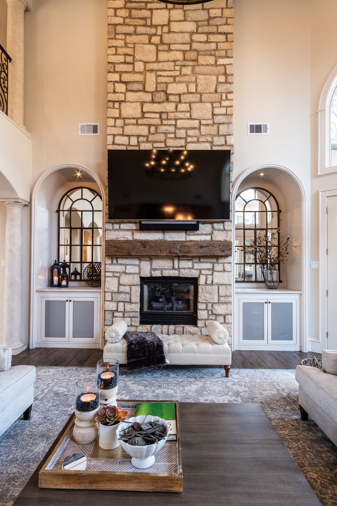 Inspiration for a large open concept family room in Houston with porcelain floors, a two-sided fireplace, a stone fireplace surround, a wall-mounted tv and brown floor.