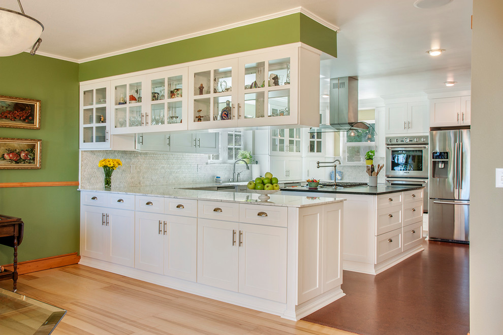 Inspiration for a timeless kitchen remodel in Seattle with shaker cabinets, white cabinets, white backsplash, stainless steel appliances and stone tile backsplash
