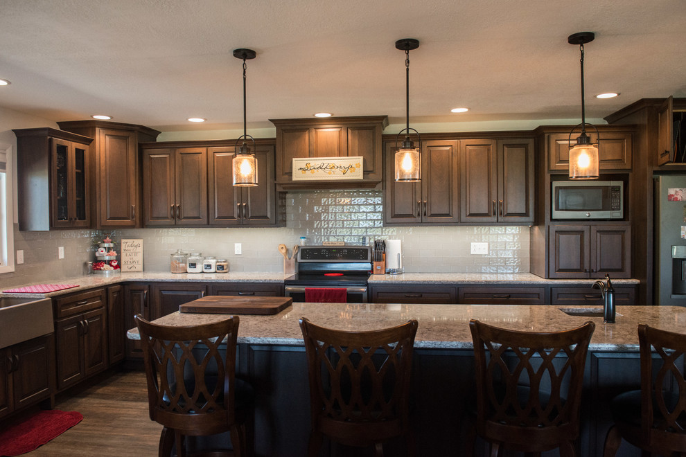 Inspiration for a huge transitional l-shaped medium tone wood floor open concept kitchen remodel with a farmhouse sink, raised-panel cabinets, medium tone wood cabinets, quartz countertops, gray backsplash, subway tile backsplash, stainless steel appliances, an island and multicolored countertops