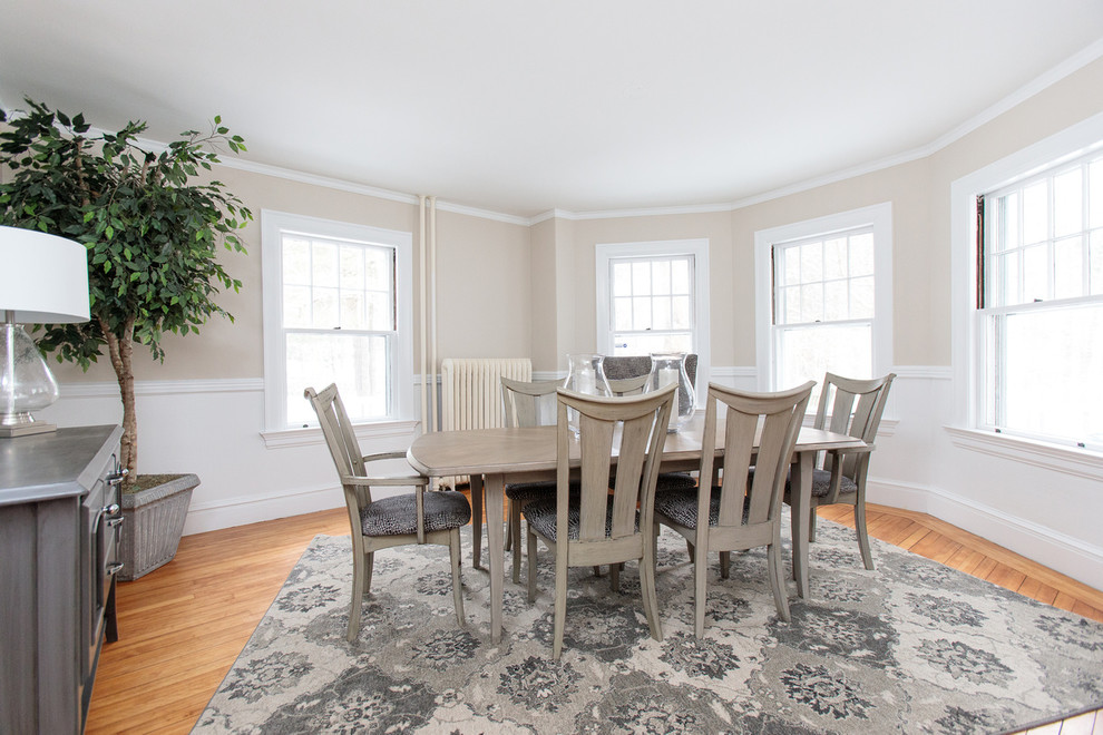 Photo of a mid-sized transitional separate dining room in Boston with beige walls and medium hardwood floors.