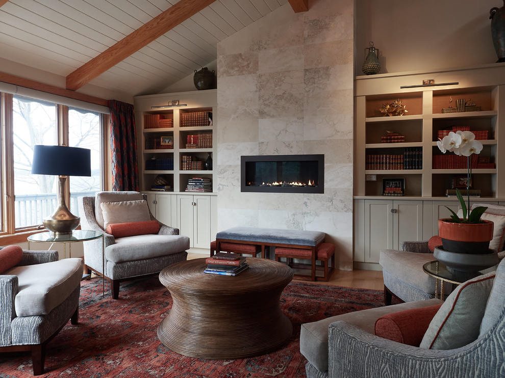 Design ideas for a transitional enclosed family room in New York with a library, grey walls, dark hardwood floors, a ribbon fireplace, a tile fireplace surround and brown floor.