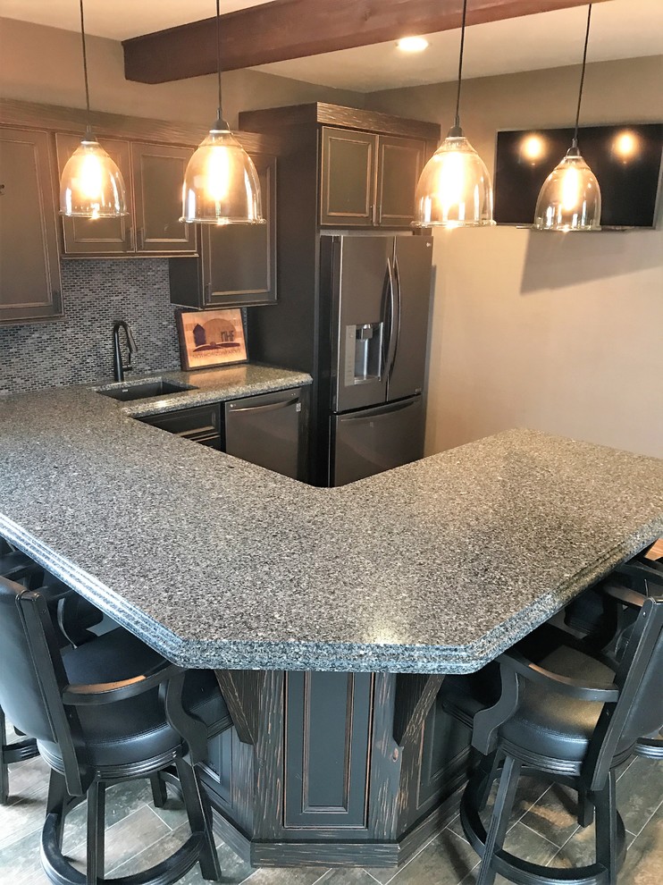 Photo of a large traditional u-shaped wet bar in Other with an undermount sink, grey cabinets, quartz benchtops, multi-coloured splashback, mosaic tile splashback, ceramic floors and grey floor.