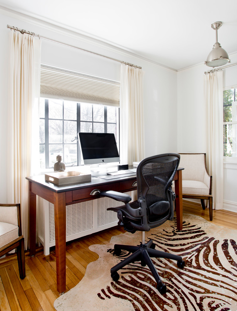 Design ideas for a small eclectic study room in New York with white walls, medium hardwood floors, a freestanding desk and no fireplace.