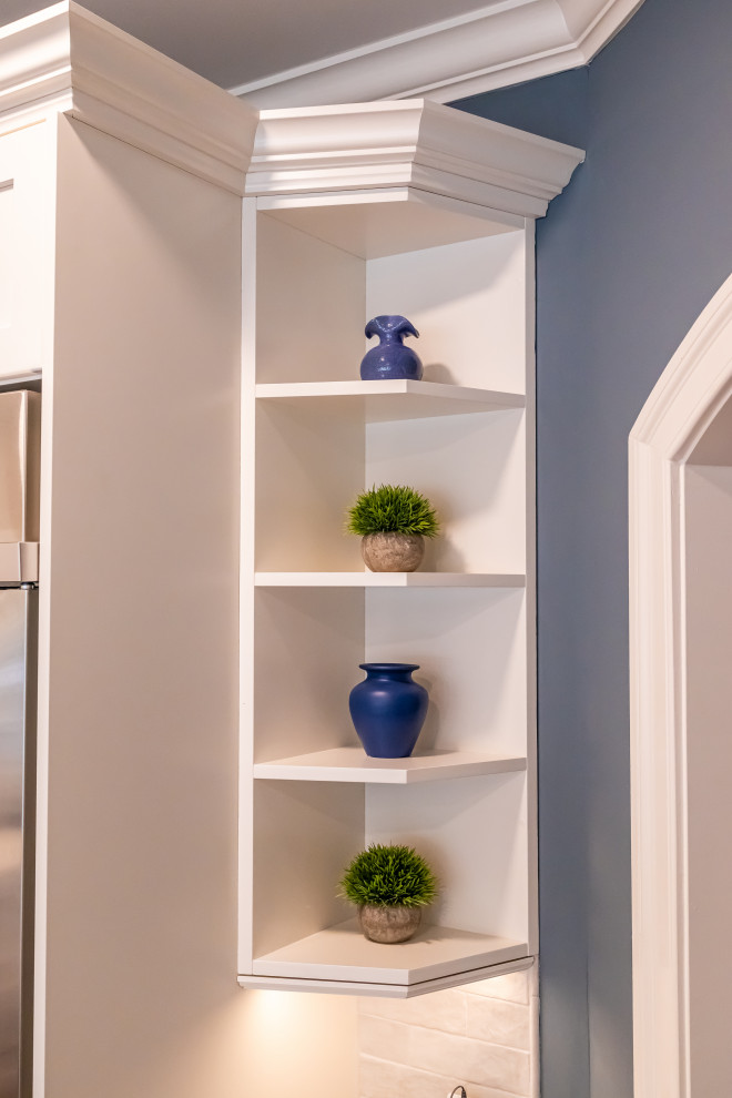 Eat-in kitchen - large transitional u-shaped medium tone wood floor and brown floor eat-in kitchen idea in Baltimore with a farmhouse sink, shaker cabinets, blue cabinets, quartz countertops, white backsplash, marble backsplash, stainless steel appliances, an island and white countertops