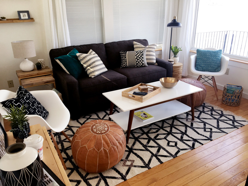 Example of a trendy enclosed medium tone wood floor and brown floor living room design in Burlington with beige walls