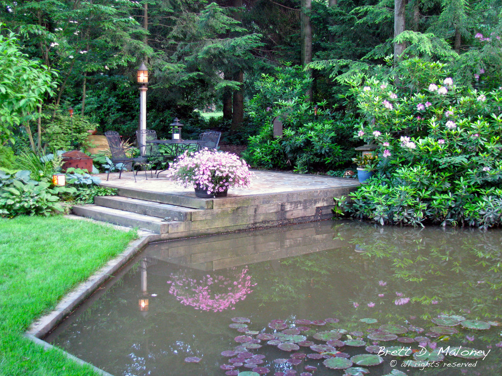 Large arts and crafts backyard partial sun garden in Other with natural stone pavers and a garden path for summer.