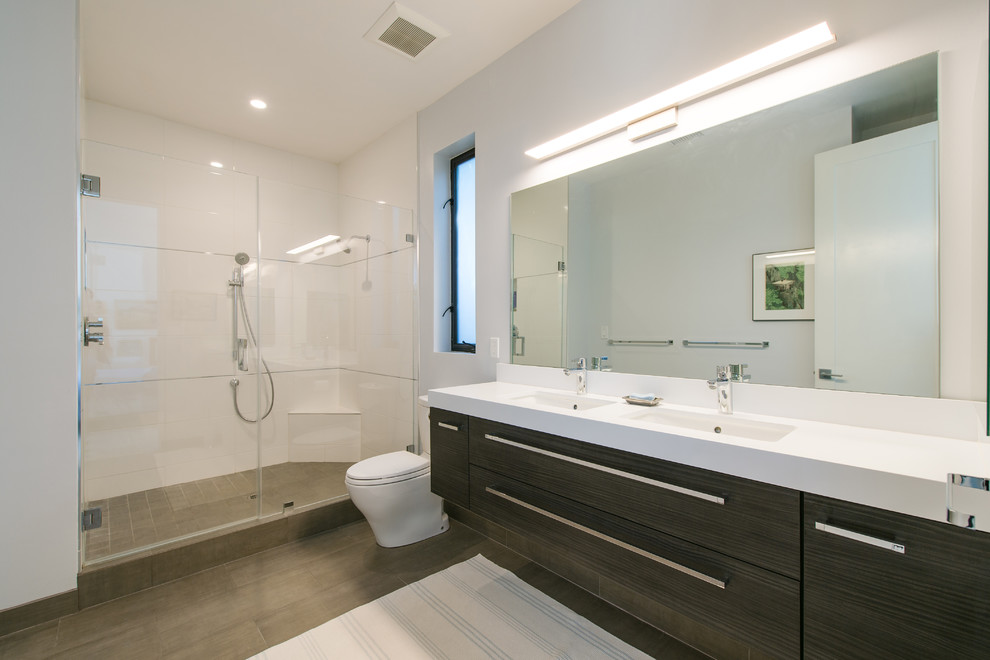 Example of a mid-sized minimalist master white tile and porcelain tile ceramic tile corner shower design in Orange County with furniture-like cabinets, dark wood cabinets, a two-piece toilet, white walls, an undermount sink and wood countertops