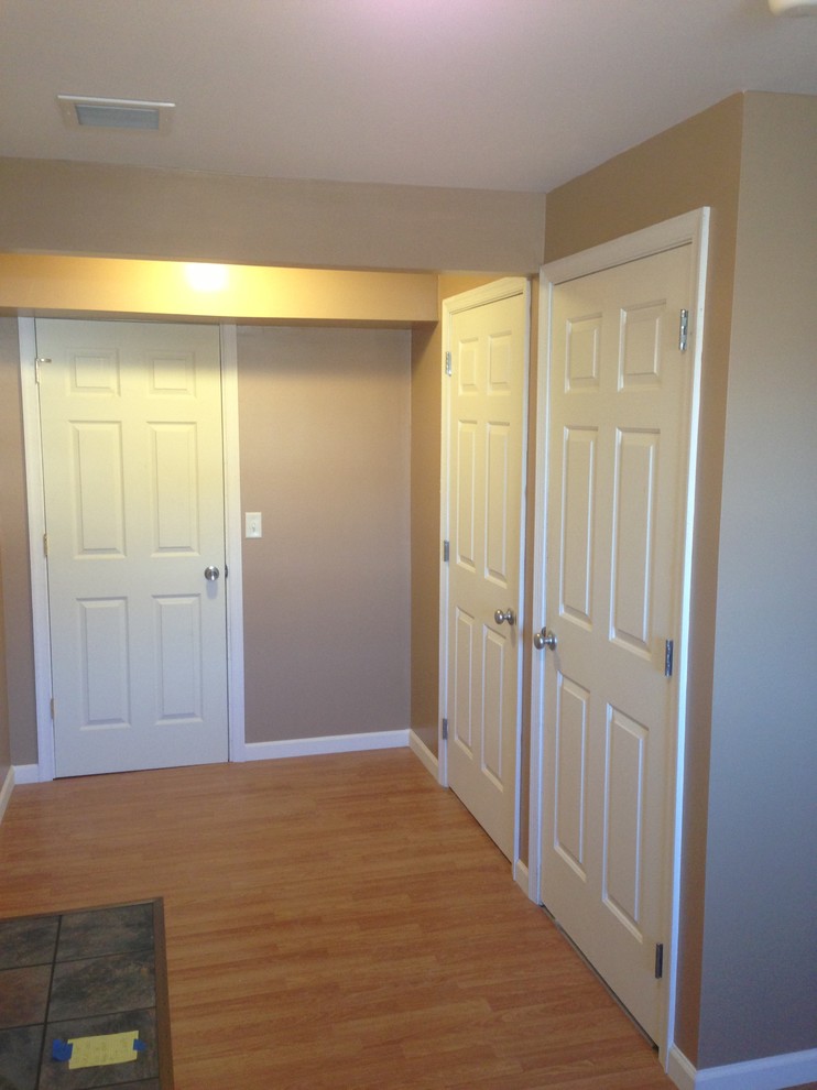 Inspiration for a transitional laminate floor mudroom remodel with beige walls
