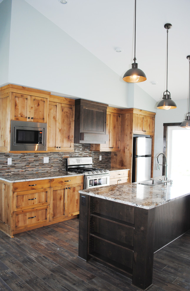 Country open plan kitchen in Other with shaker cabinets, light wood cabinets, stainless steel appliances and with island.