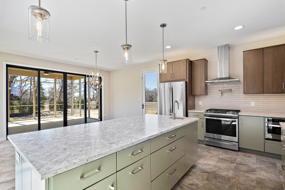 Example of a large minimalist l-shaped open concept kitchen design in DC Metro with an undermount sink, flat-panel cabinets, quartz countertops, beige backsplash, subway tile backsplash, stainless steel appliances, an island and multicolored countertops