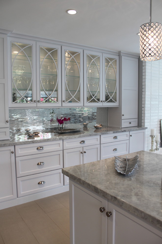 Photo of a contemporary kitchen in Los Angeles with raised-panel cabinets, white cabinets and with island.