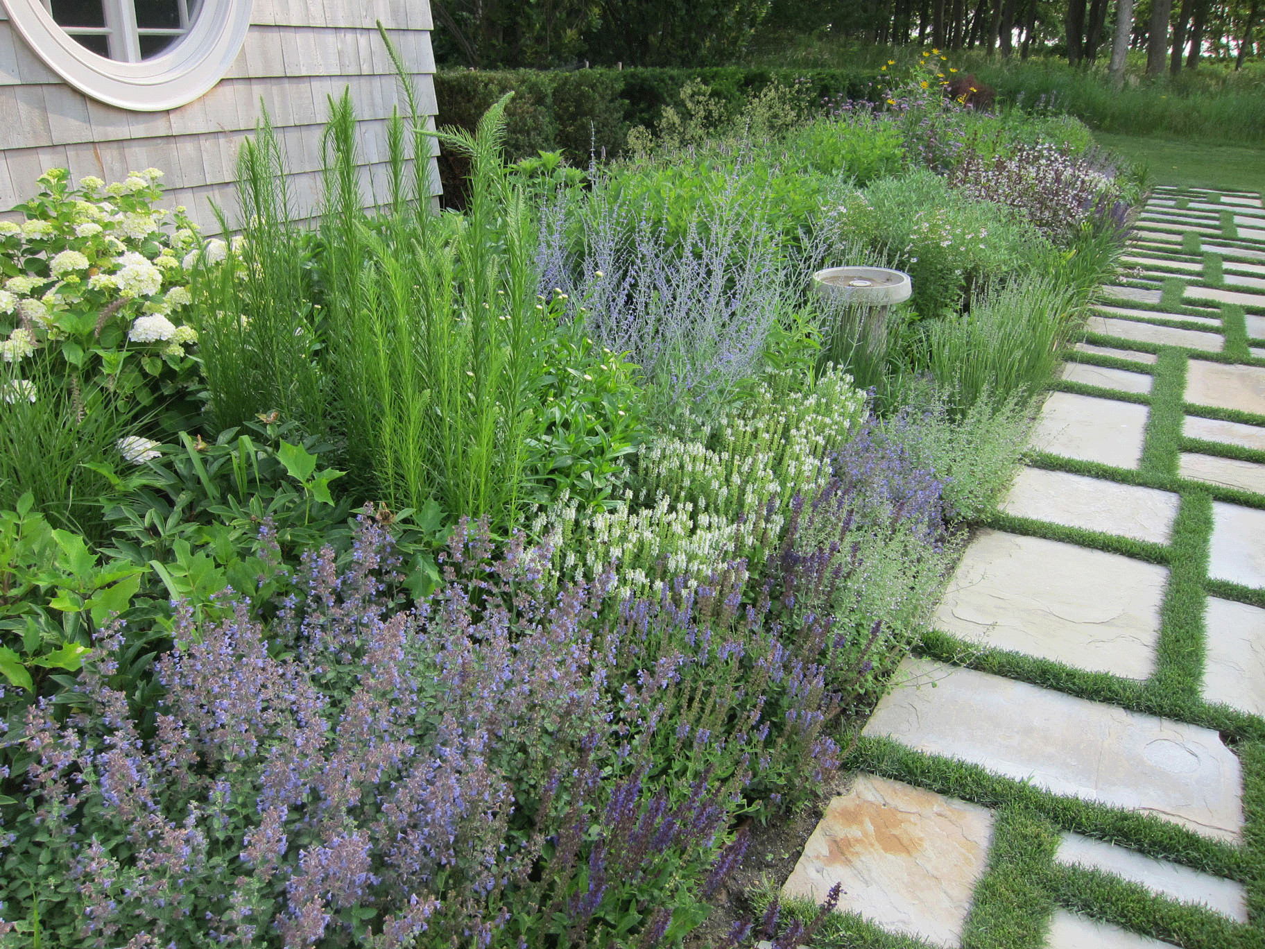 herb garden and flagstone pavers with grass joints by Peter Atkins