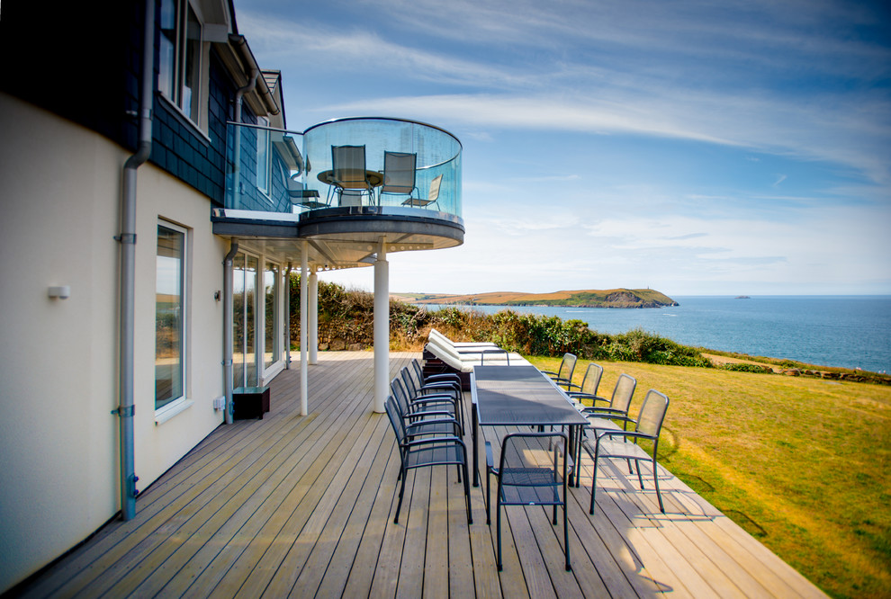 Beach style backyard deck in Cornwall with no cover.