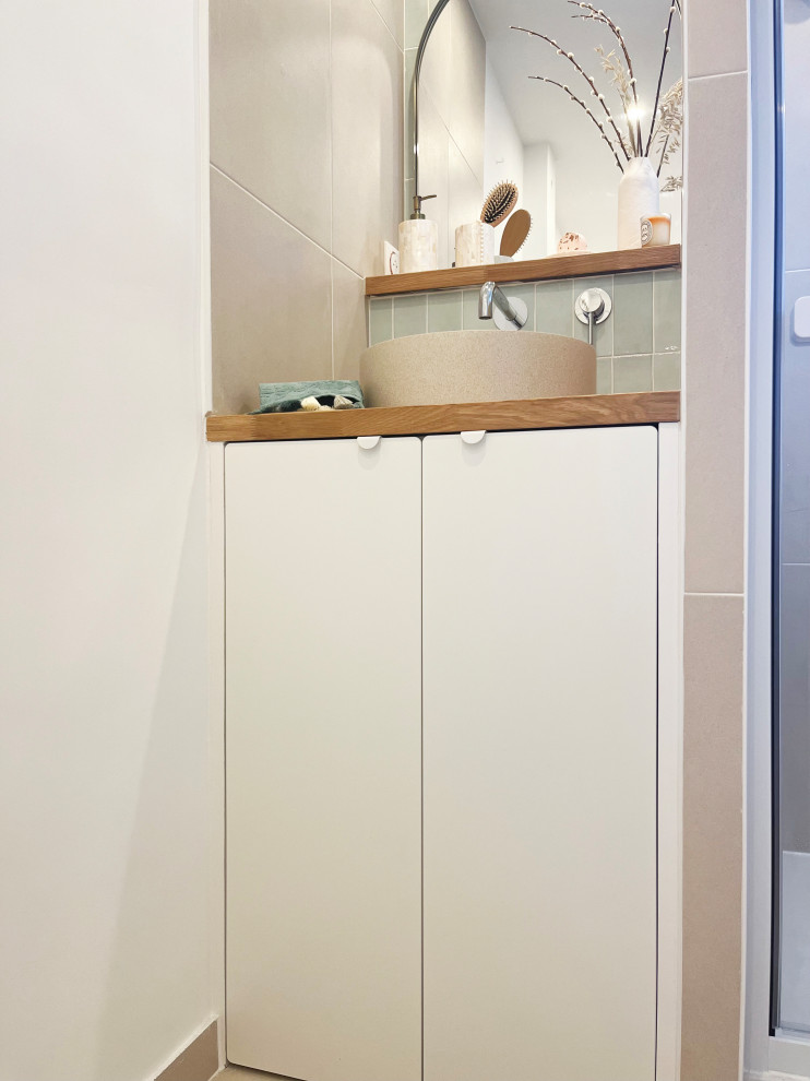 Photo of a small contemporary bathroom in Paris with flat-panel cabinets, white cabinets, green walls, ceramic floors and beige floor.