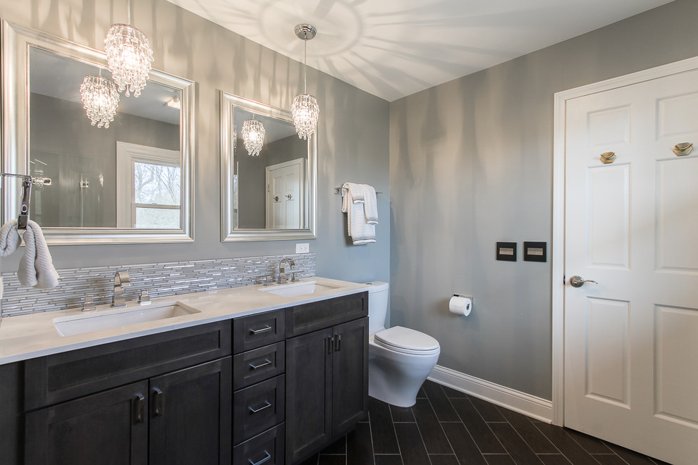 Design ideas for a large traditional 3/4 bathroom in Chicago with an undermount sink, shaker cabinets, grey cabinets, engineered quartz benchtops, an alcove shower, a one-piece toilet, gray tile, porcelain tile, grey walls, porcelain floors and brown floor.