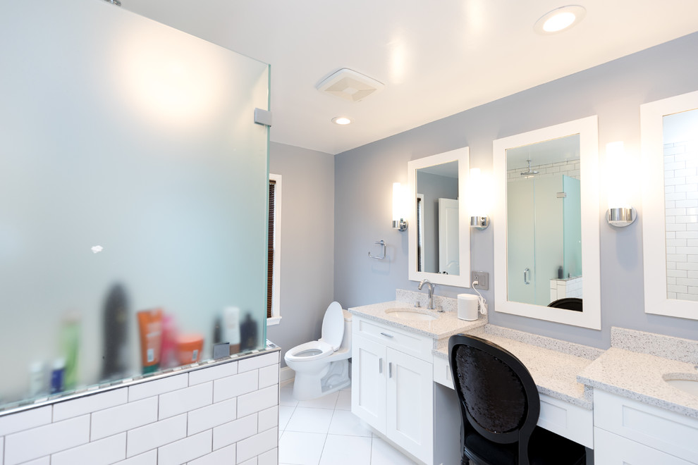 Mid-sized contemporary 3/4 bathroom in DC Metro with recessed-panel cabinets, white cabinets, an alcove tub, a shower/bathtub combo, a two-piece toilet, white tile, subway tile, white walls, ceramic floors, an undermount sink, solid surface benchtops, white floor and a sliding shower screen.