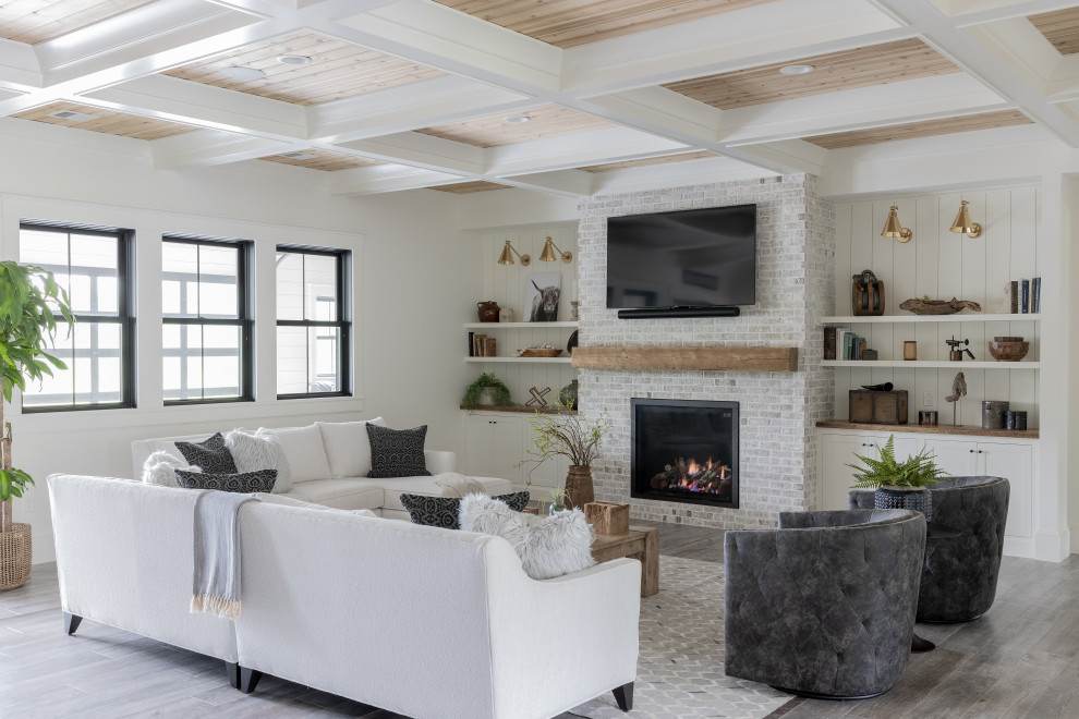 Transitional open concept living room in Providence with white walls, medium hardwood floors, a standard fireplace, a brick fireplace surround, a wall-mounted tv, grey floor, coffered, wood and planked wall panelling.