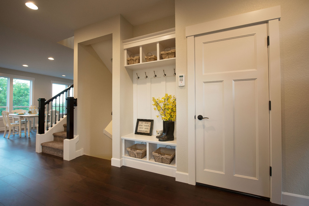 This is an example of a mid-sized traditional foyer in Portland with beige walls, dark hardwood floors, a single front door and a white front door.