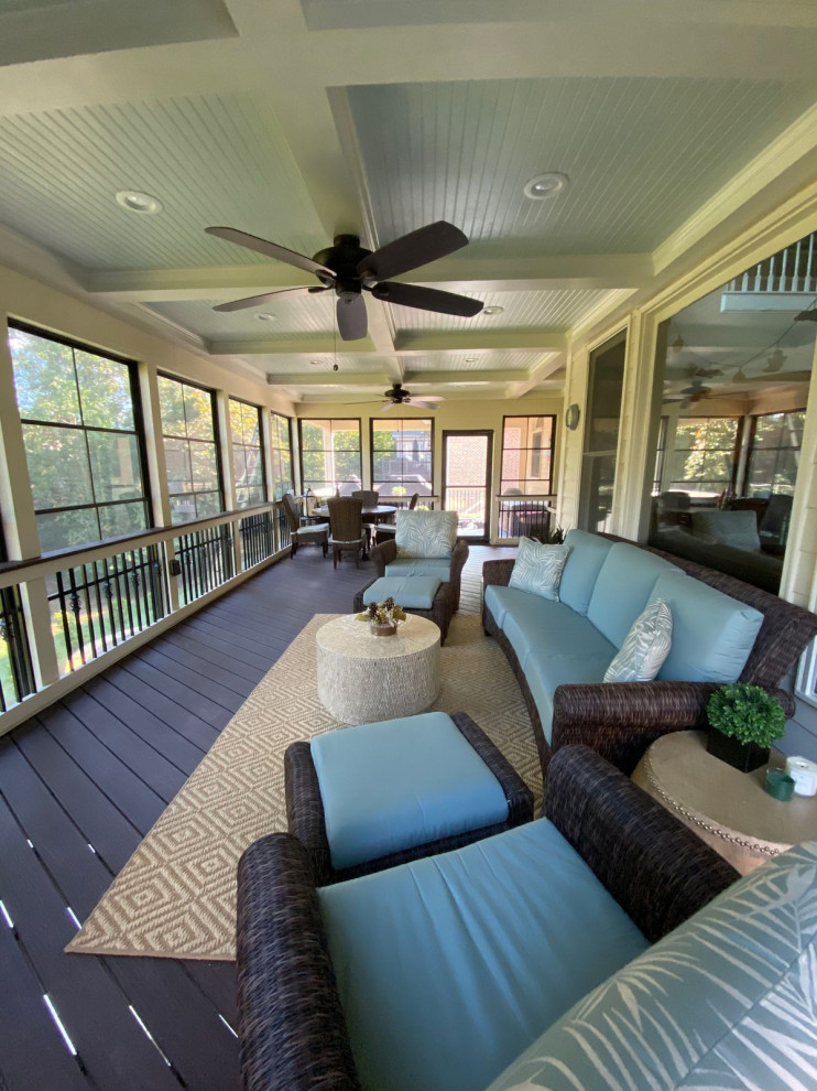 Photo of an expansive eclectic back mixed railing veranda in Charlotte with a fireplace and a roof extension.
