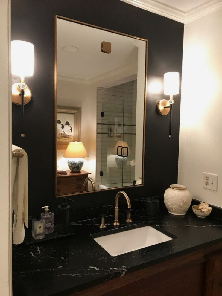 Example of a mid-sized transitional black and white tile and porcelain tile single-sink bathroom design in Nashville with brown cabinets, black walls, an undermount sink, soapstone countertops, a hinged shower door, black countertops and a freestanding vanity