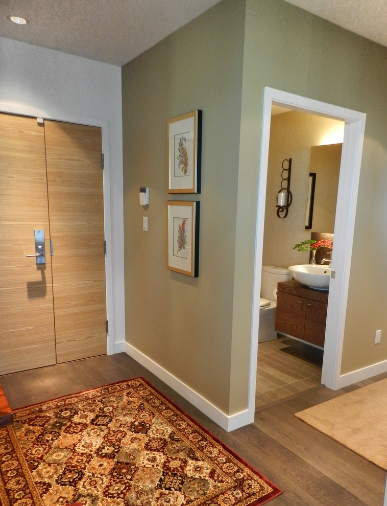 Small transitional front door in Vancouver with beige walls, medium hardwood floors, a single front door, a light wood front door and grey floor.
