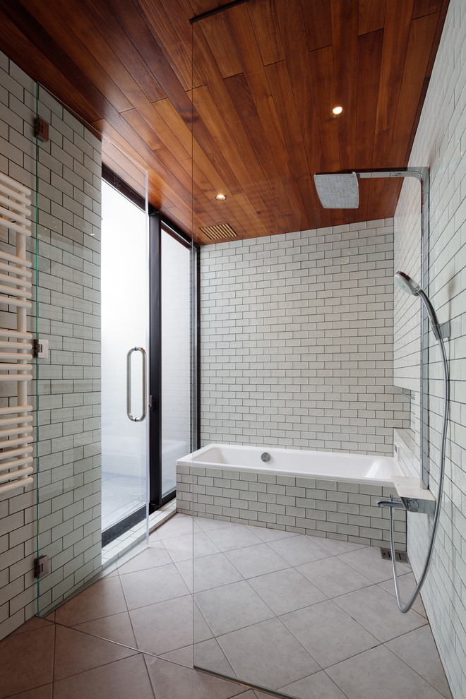 Design ideas for an asian wet room bathroom in Other with a drop-in tub, white tile, subway tile, white walls, beige floor and a hinged shower door.