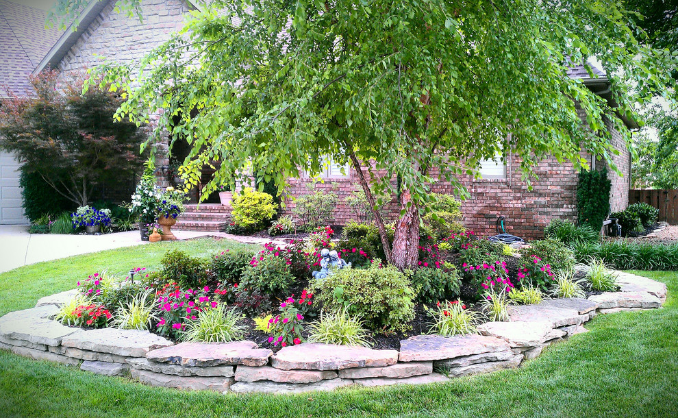 Photo of a mid-sized transitional full sun front yard landscaping for spring.