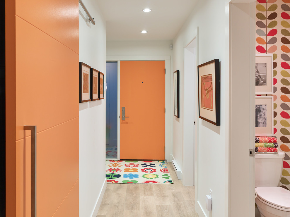 Midcentury hallway in Vancouver with white walls and light hardwood floors.