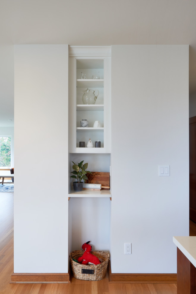 Kitchen - mid-sized transitional u-shaped medium tone wood floor kitchen idea in Seattle with a farmhouse sink, beaded inset cabinets, white cabinets, quartz countertops, green backsplash, porcelain backsplash, stainless steel appliances, an island and white countertops