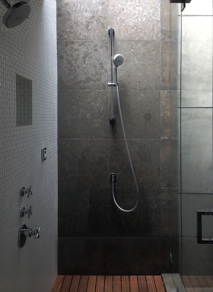 Design ideas for a mid-sized industrial master bathroom in Orange County with a double shower, gray tile, stone slab, grey walls, medium hardwood floors, a vessel sink, flat-panel cabinets, medium wood cabinets, engineered quartz benchtops and a one-piece toilet.