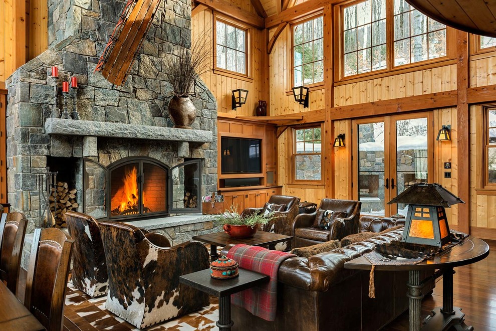 Inspiration for a large country open concept family room in Burlington with a standard fireplace, a stone fireplace surround and a wall-mounted tv.