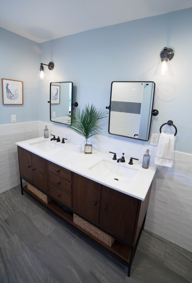 Mid-sized contemporary kids bathroom in San Luis Obispo with furniture-like cabinets, dark wood cabinets, an alcove tub, a shower/bathtub combo, a one-piece toilet, white tile, ceramic tile, blue walls, porcelain floors, an undermount sink, engineered quartz benchtops, grey floor, a shower curtain and white benchtops.