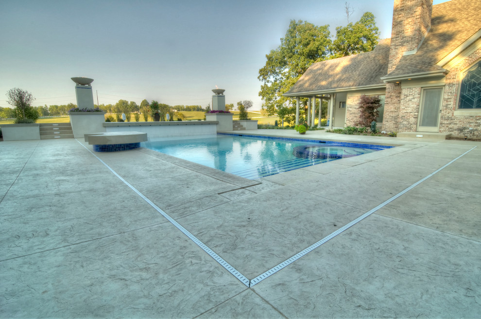 Example of a large transitional backyard concrete paver and rectangular natural hot tub design in Cedar Rapids