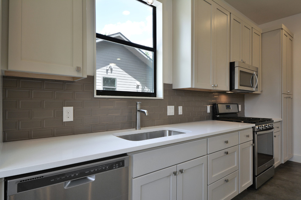 Inspiration for a modern kitchen remodel in Austin with white cabinets, quartz countertops, gray backsplash, subway tile backsplash and stainless steel appliances