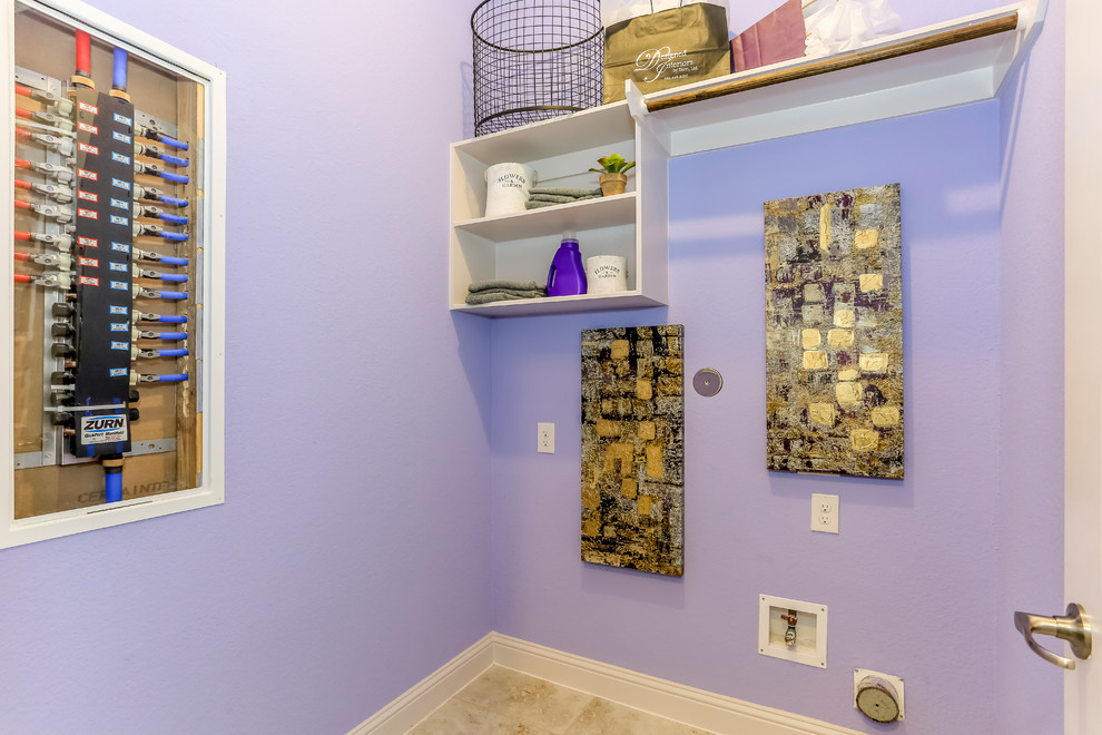 Inspiration for a mid-sized single-wall dedicated laundry room in Houston with open cabinets, white cabinets, purple walls, ceramic floors, a side-by-side washer and dryer and black floor.