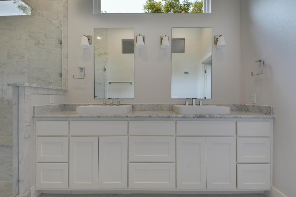 Mid-sized modern master bathroom in Austin with a vessel sink, shaker cabinets, white cabinets, marble benchtops, a claw-foot tub, a corner shower, a one-piece toilet, gray tile, stone tile, grey walls and marble floors.