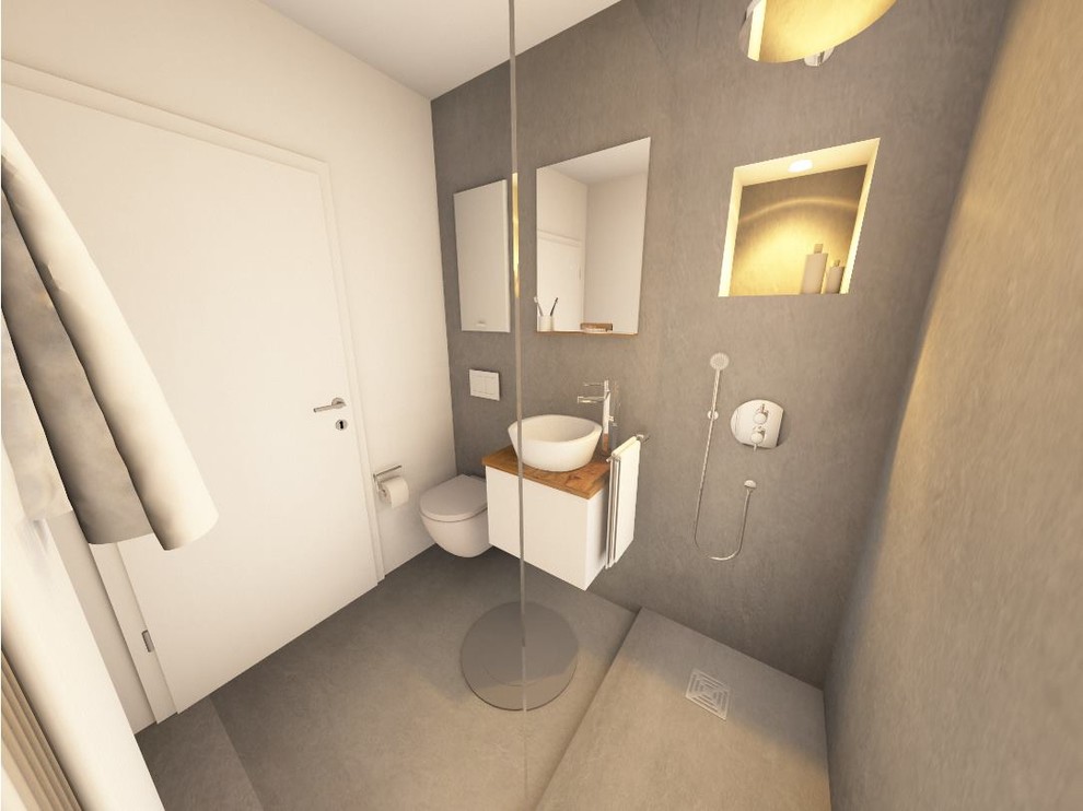 Duschbad mit Kassettenfronten, weißen Schränken, offener Dusche, Wandtoilette, grauer Wandfarbe, Betonboden, Aufsatzwaschbecken, Waschtisch aus Holz, grauem Boden und brauner Waschtischplatte in Hamburg