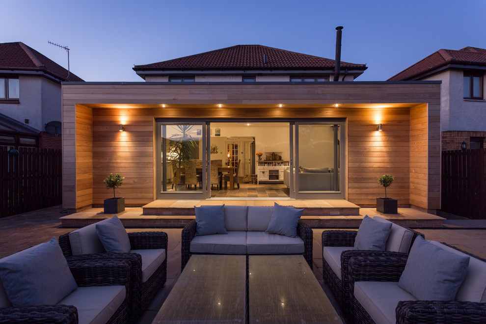 Large contemporary back patio in Other with no cover.