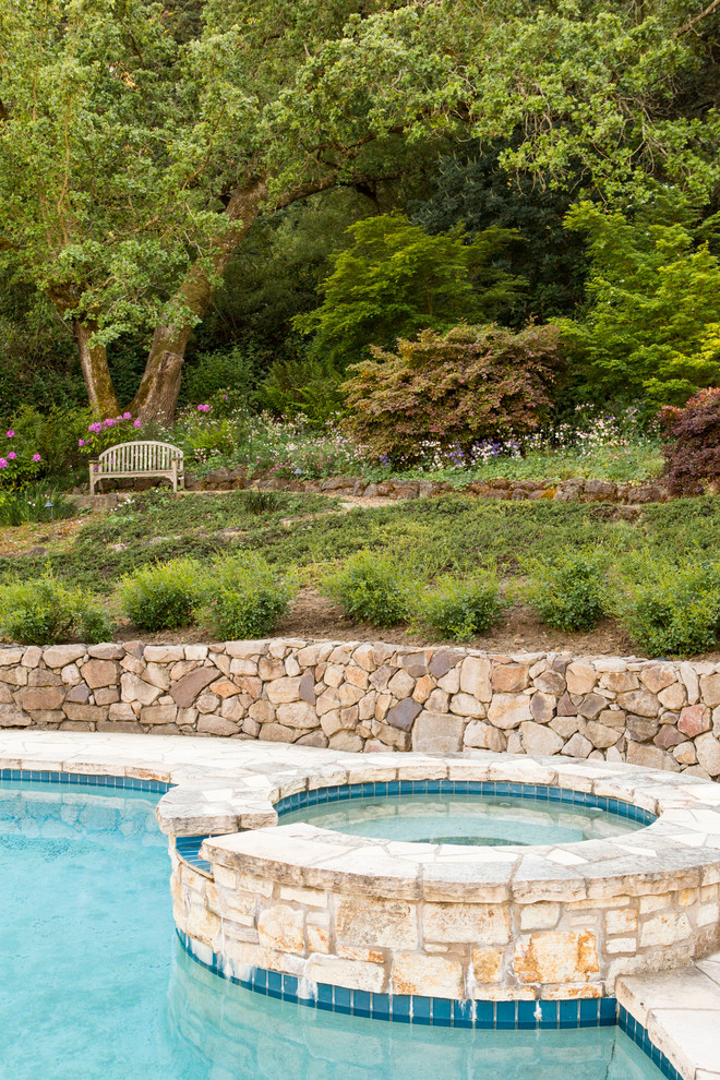 Design ideas for a large rustic drought-tolerant and partial sun backyard gravel retaining wall landscape.