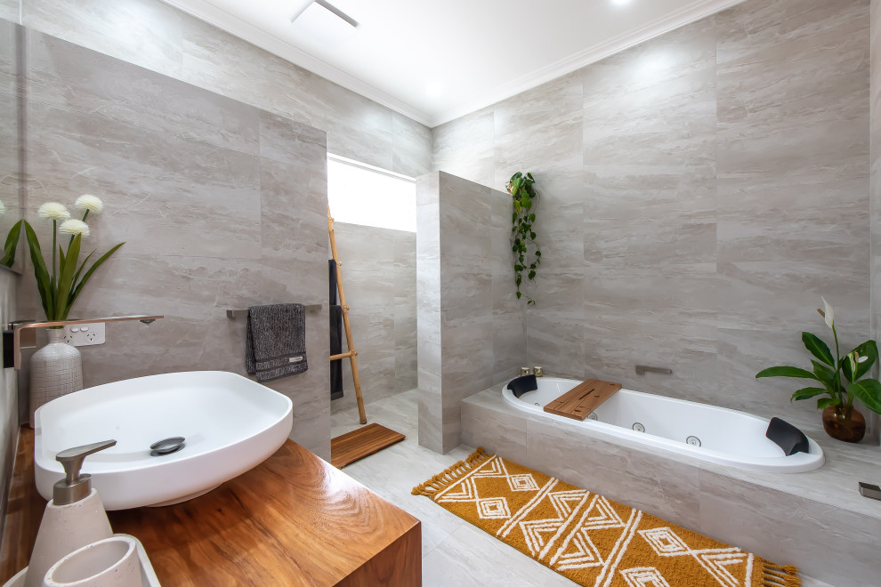 Design ideas for a contemporary bathroom in Perth with medium wood cabinets, a drop-in tub, an open shower, gray tile, ceramic tile, ceramic floors, a vessel sink, wood benchtops, grey floor, a single vanity and a floating vanity.
