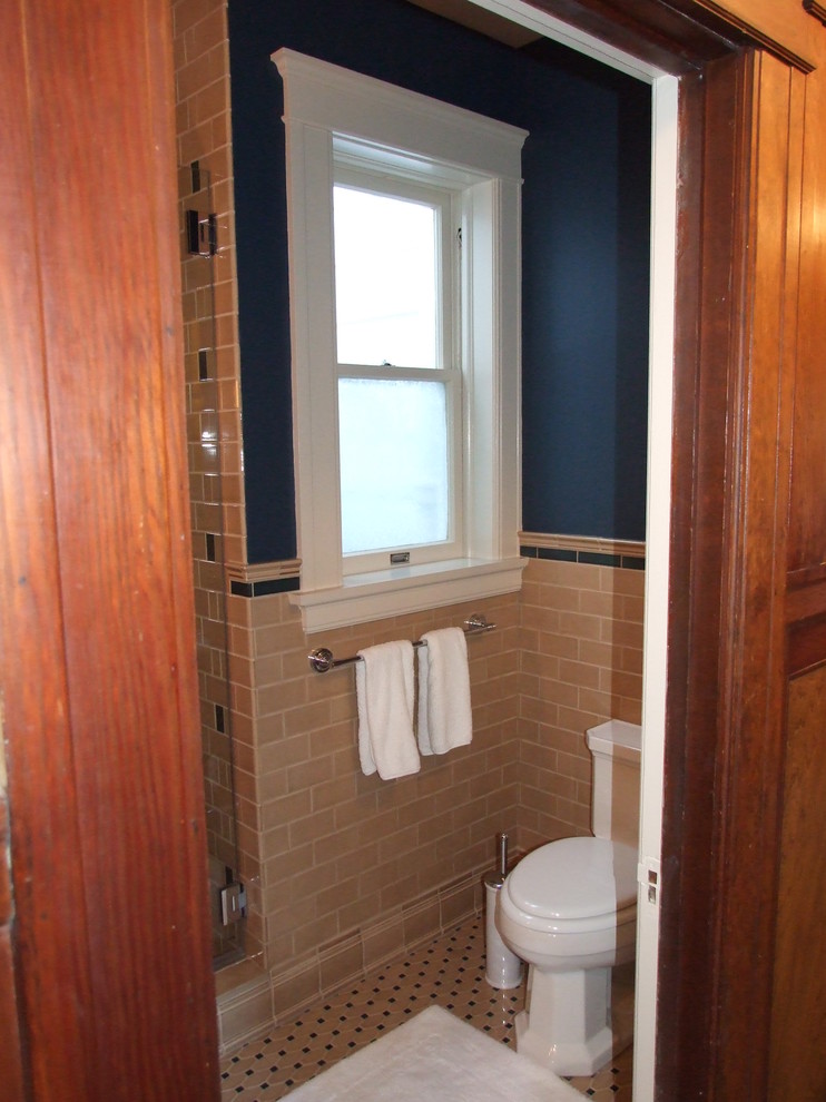 Photo of a mid-sized contemporary 3/4 bathroom in San Francisco with a corner shower, beige tile, subway tile, blue walls, mosaic tile floors, shaker cabinets, medium wood cabinets and an undermount sink.