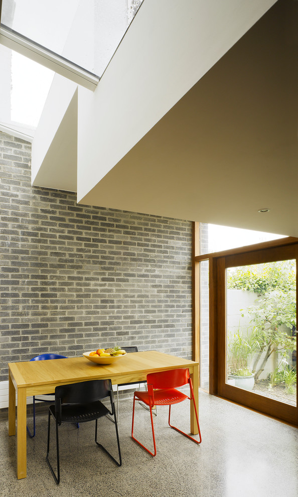Photo of a modern dining room in Dublin with concrete floors.