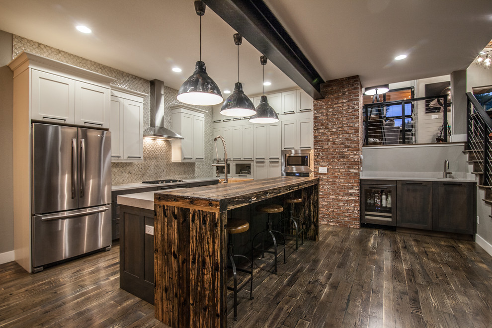 Transitional kitchen in Denver with shaker cabinets, white cabinets, grey splashback, stainless steel appliances, dark hardwood floors and with island.
