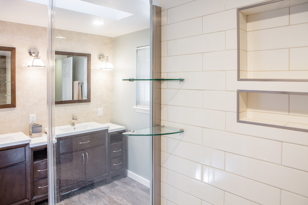 Design ideas for a large traditional master bathroom in Denver with flat-panel cabinets, dark wood cabinets, an alcove shower, a one-piece toilet, beige tile, ceramic tile, grey walls, porcelain floors, an integrated sink, engineered quartz benchtops, brown floor and a hinged shower door.