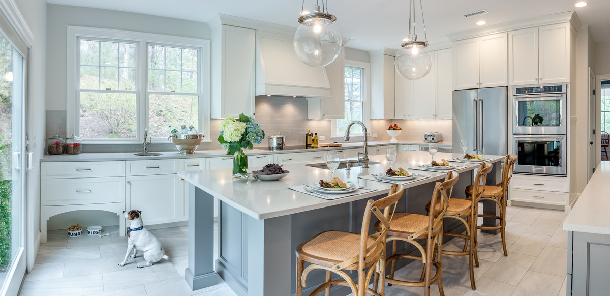 Transitional kitchen photo in Boston with an undermount sink, gray cabinets, quartzite countertops, subway tile backsplash, stainless steel appliances and an island