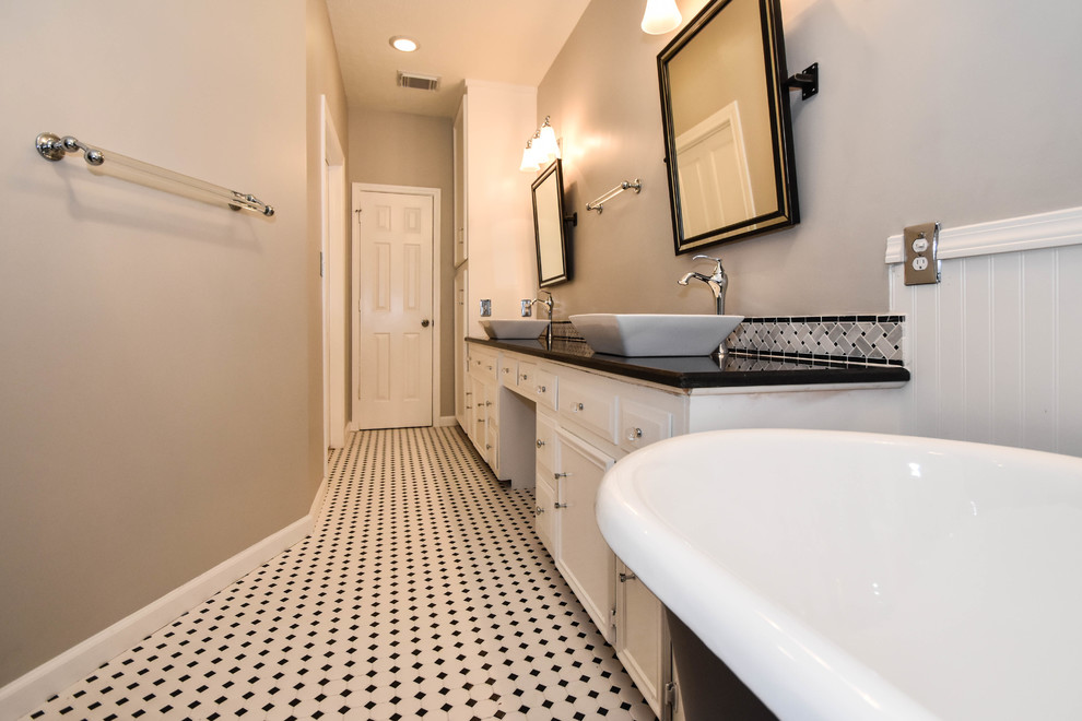 This is an example of a transitional master bathroom in Houston with raised-panel cabinets, white cabinets, a claw-foot tub, an open shower, a one-piece toilet, black and white tile, mosaic tile, grey walls, mosaic tile floors, a vessel sink and granite benchtops.