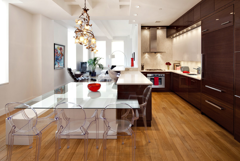 This is an example of a contemporary u-shaped open plan kitchen in New York with an undermount sink, flat-panel cabinets, dark wood cabinets, beige splashback and stainless steel appliances.