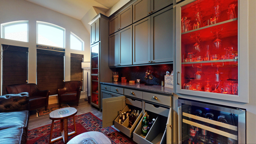 Large traditional single-wall home bar in Dallas with no sink, shaker cabinets, grey cabinets, granite benchtops, brown splashback, ceramic splashback, ceramic floors, grey floor and grey benchtop.