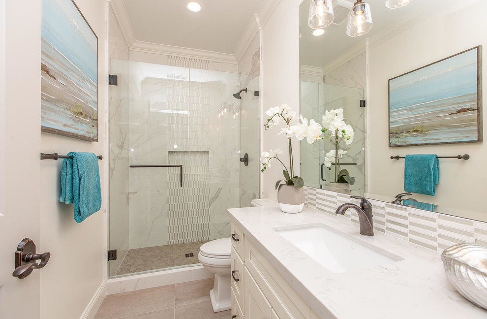 Design ideas for a transitional 3/4 bathroom in San Francisco with shaker cabinets, white cabinets, an alcove shower, a two-piece toilet, gray tile, white tile, matchstick tile, white walls, an undermount sink, beige floor, a hinged shower door and white benchtops.