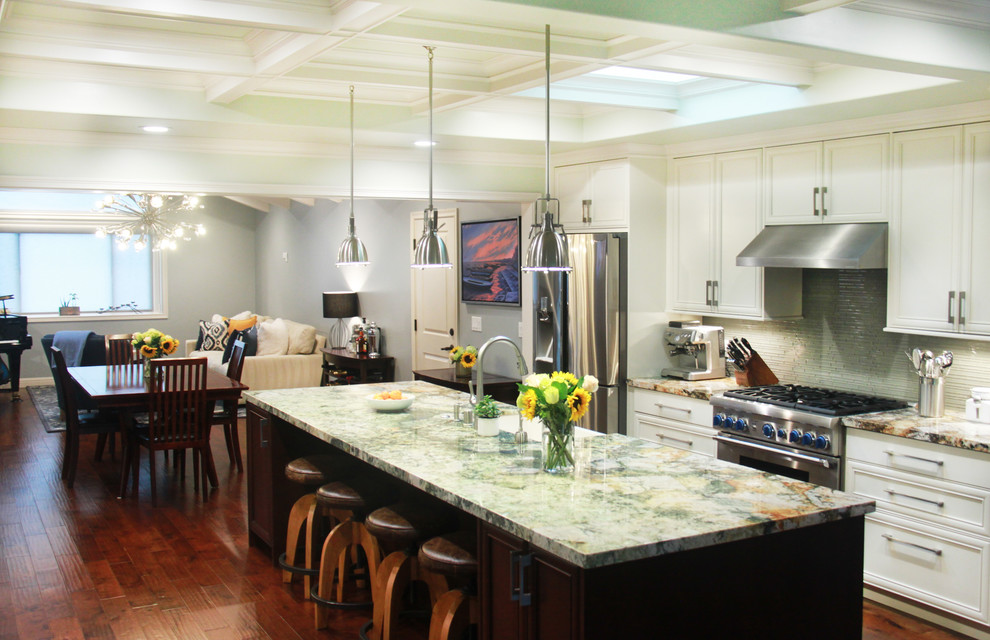 Eat-in kitchen - mid-sized transitional u-shaped dark wood floor and brown floor eat-in kitchen idea in San Francisco with a farmhouse sink, recessed-panel cabinets, white cabinets, granite countertops, green backsplash, glass tile backsplash, stainless steel appliances, an island and multicolored countertops